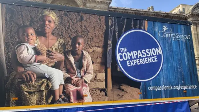 A banner showing an African mother with her two children