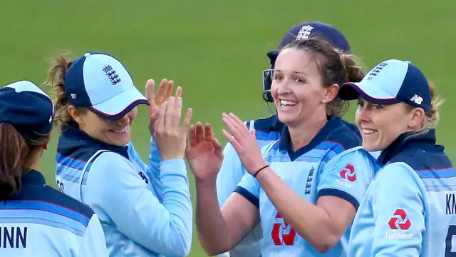 Kate Cross celebrates with her England team-mates after taking a wicket in the third ODI against West Indies in Chelmsford