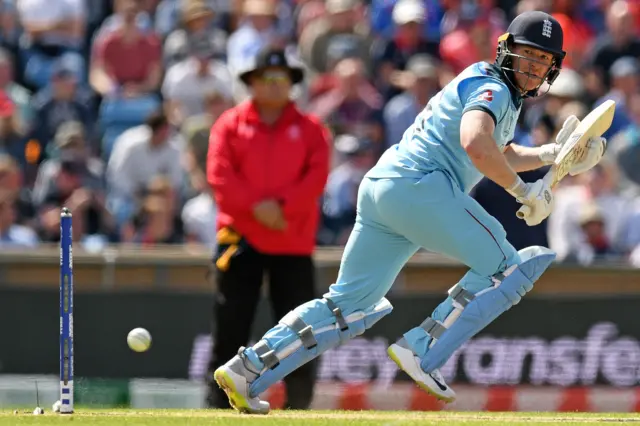 Eoin Morgan (R) watches the ball after playing a shot