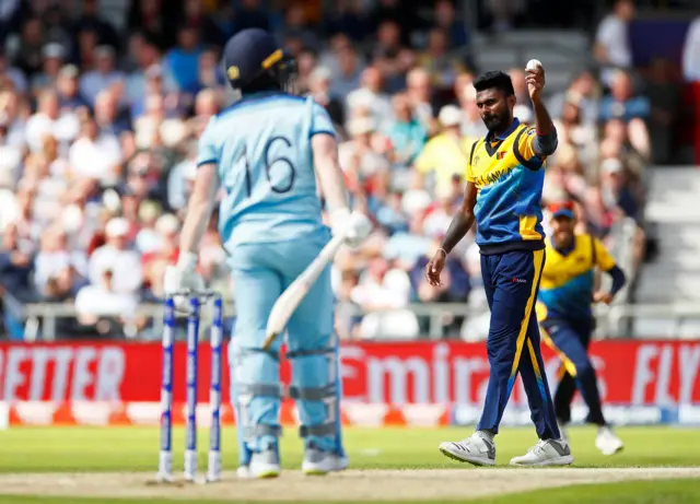 Isuru Udana celebrates after he caught and bowled England's Eoin Morgan