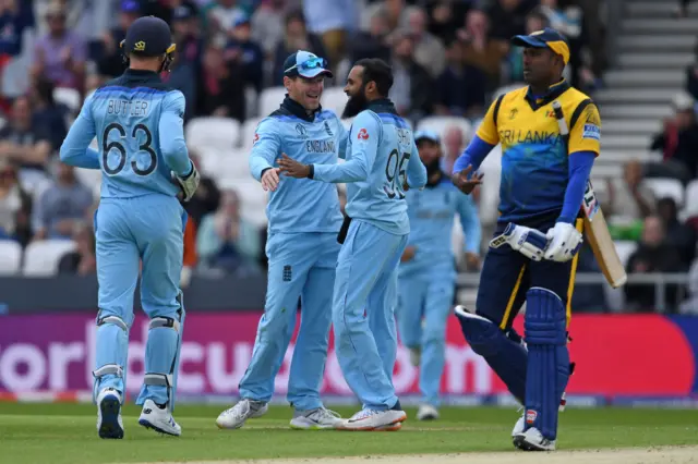 England"s Adil Rashid (2R) and England"s captain Eoin Morgan (2L) celebrate taking the wicket of Sri Lanka"s Kusal Mendis for 46 runs