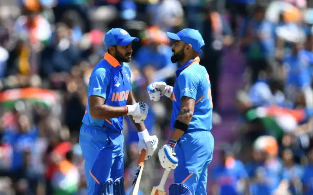 Virat Kohli (R) celebrates after scoring a half-century (50 runs) with teammate India"s Vijay Shankar