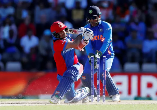 Asghar Afghan is bowled out by India's Yuzvendra Chahal