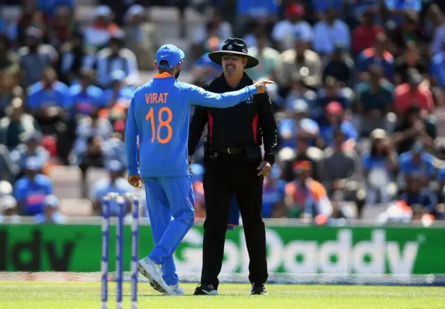 Virat Kohli of India talks to umpire Richard Illingworth after his unsuccessful review