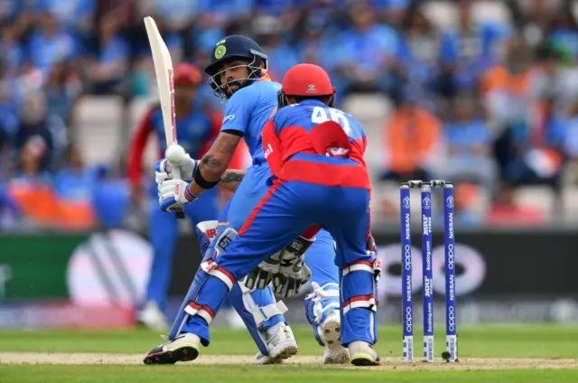 Virat Kohli (L) plays a shot past Afghanistan"s Ikram Ali Khil