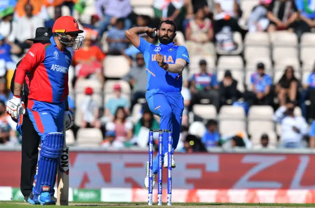 Mohammed Shami (C) delivers a ball during the 2019 Cricket World Cup group stage match between India and Afghanistan