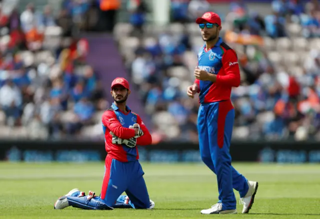 Ikram Ali Khil reacts after dropping a catch