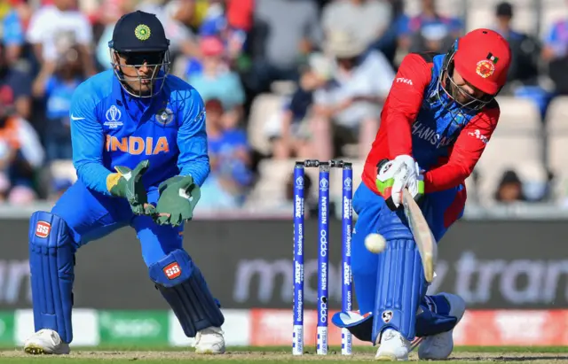 Rashid Khan (R) plays a reverse sweep shot