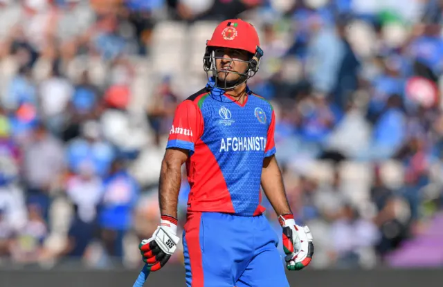 Najibullah Zadran walks back to the pavilion after his dismissal