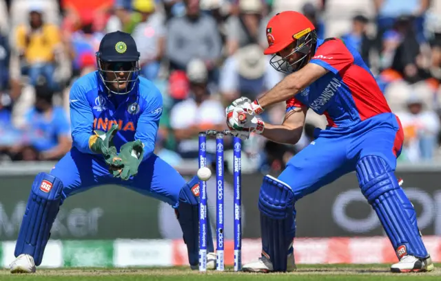 Rahmat Shah (R) is watched by India's Mahendra Singh Dhoni