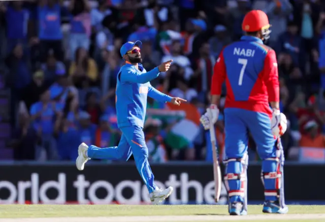 Virat Kohli celebrates the wicket of Afghanistan"s Mohammad Nabi