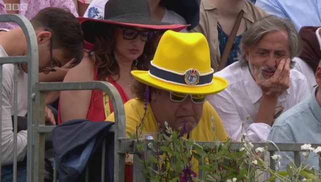 A man in a bright yellow hat