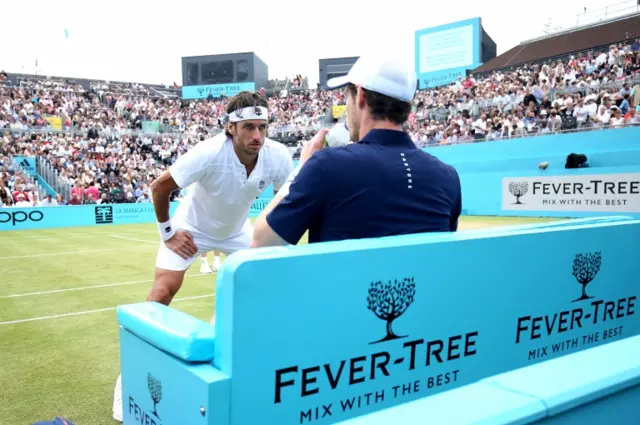Feliciano Lopez stands at the changeover