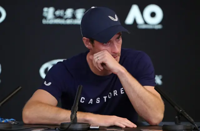 Murray wipes away tears in a news conference