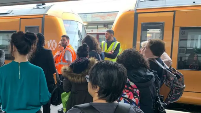 Passengers and staff on the platform