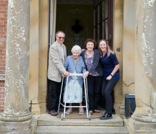 Kath on the Hall steps with her family.