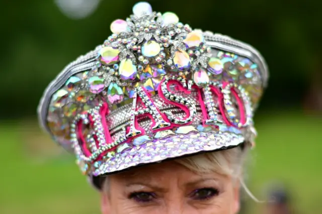 Woman wearing "Glasto" hat