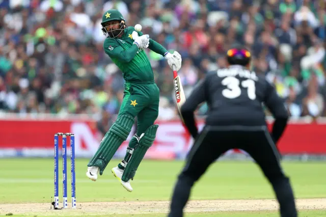 Muhammad Hafeez tries to evade a Lockie Ferguson bouncer