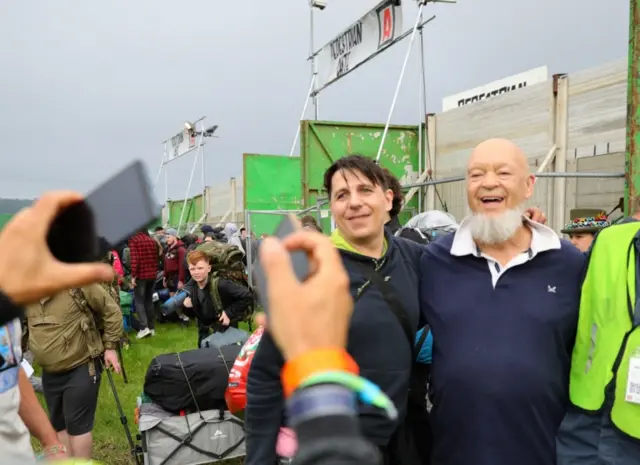 Michael Eavis poses for photos