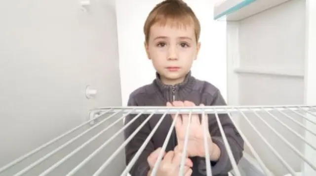 Child at empty fridge