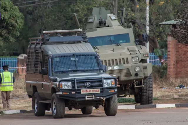 Amoured Malawi Defence Force vehicles stay parked as Malawi Police officers manage Malawi opposition party supporters and members gathered outside Lilongwe High Court in Lilongwe, Malawi, on June 26, 2019