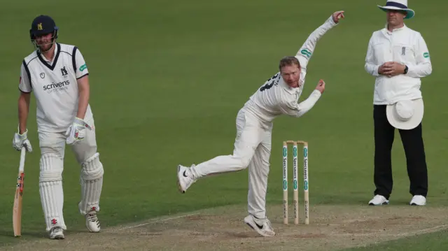 Gareth Batty of Surrey bowls as Warwickshire"s Dominic Sibley looks on during Day Three