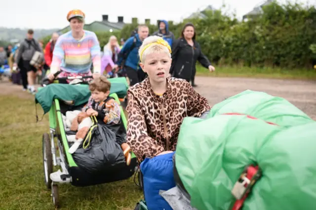 Child pushing camping kit