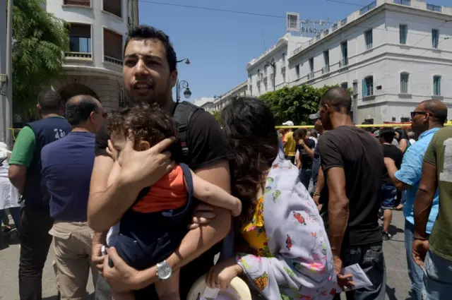 Man holding a baby near the bombing site