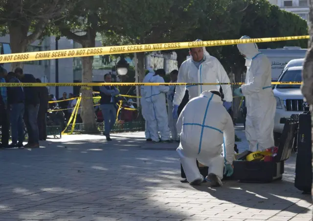 Forensics inspecting the site of one of the suicide attacks