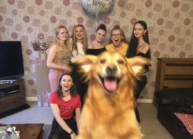 Dog photobombs birthday pic