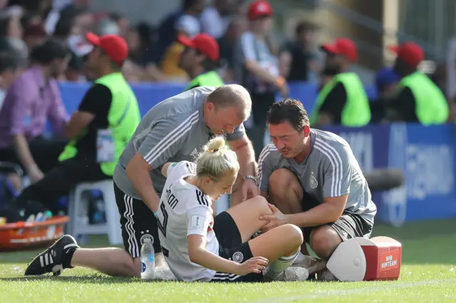 Germany's Carolin Simon gets treatment