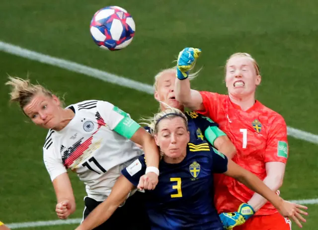 Hedvig Lindahl punches clear under pressure from Alex Popp