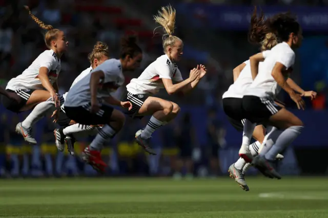 Germany players jump on the spot in their pre-match warm-up