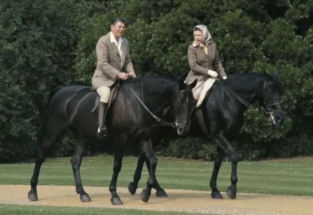 The Queen rides in the grounds of Windsor Castle with President Ronald Reagan during his state visit to the UK in 1982.