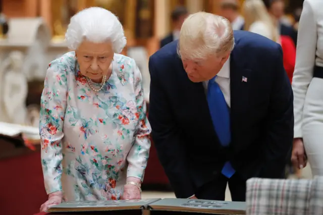 Queen Elizabeth II with US President Donald Trump view a special exhibition in the Picture Gallery of items from the Royal Collection of historical significance to the US, following a private lunch at Buckingham Palace in London, on day one of his three day state visit to the UK