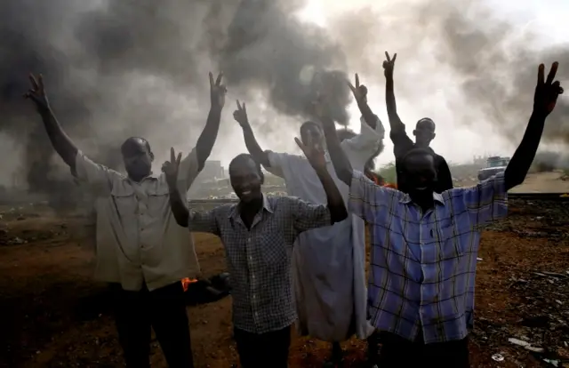 People raising their arms