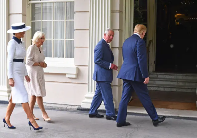 US President Donald Trump and his wife Melania (left) arrive at Clarence House in London to take tea with the Prince of Wales and Duchess of Cornwall on the first day of his state visit to the UK.