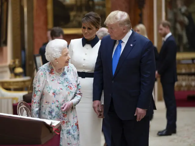 Donald Trump being shown the collection by the Queen