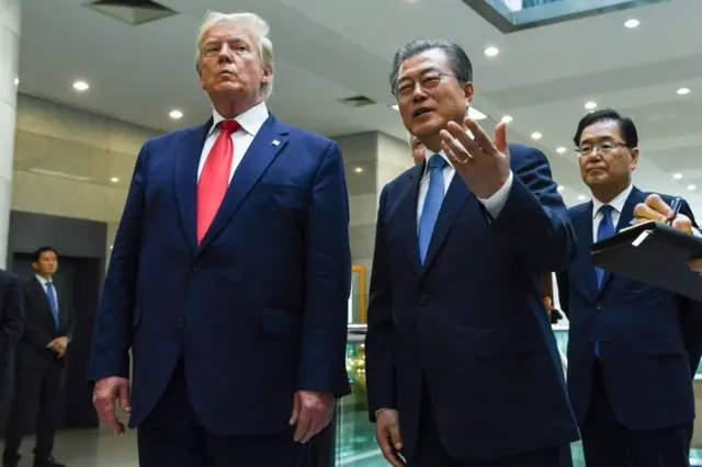 South Korea"s President Moon Jae-in speaks to the press as US President Donald Trump looks on following a meeting with North Korea"s leader Kim Jong Un on the south side of the Military Demarcation Line that divides North and South Korea, in the Joint Security Area (JSA) of Panmunjom in the Demilitarized zone (DMZ) on June 30, 201