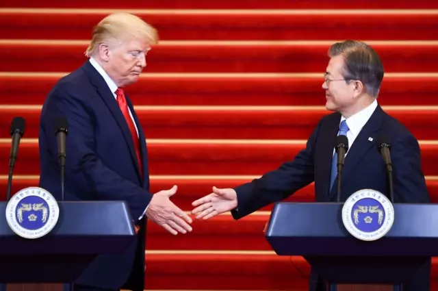 Donald Trump and Moon Jae-in shake hands in Seou