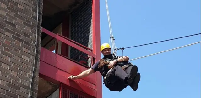 DOG AND FIREMAN ABSEILING