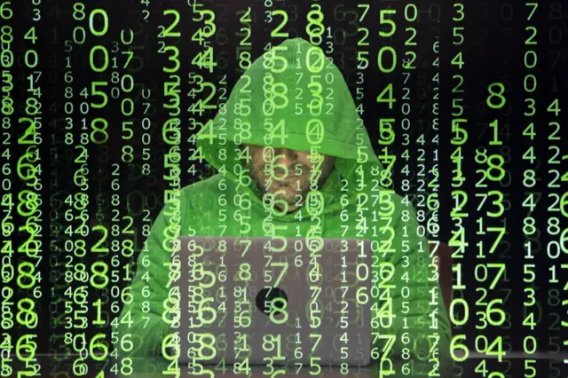 An image of a hacker using a lap with code superimposed in the foregroun