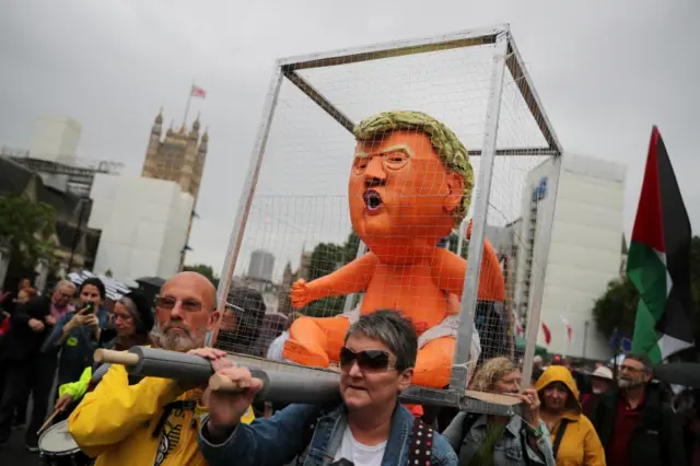 A Trump effigy in a cage