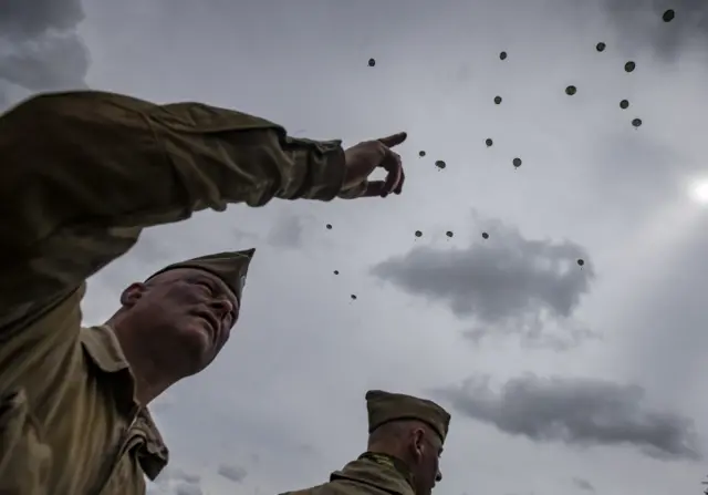 The parachutists make their way down