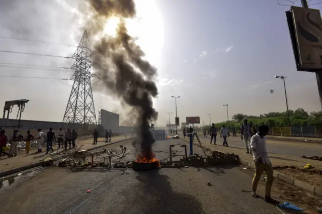 Burning tyres in the road in Sudan