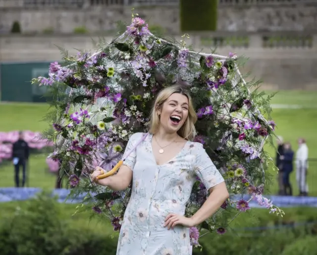 Flower show attendee Ellie Mainwaring with a flowery parasol by Jonathan Moseley