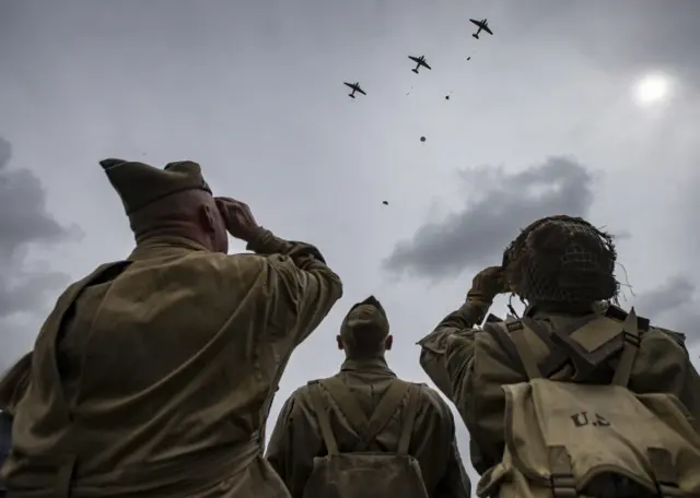 A crowd gazes up at the planes