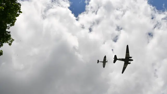 Dakota and a Spitfire fly overhead