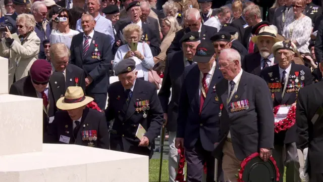 Veterans pay tribute to fallen servicemen at Bayeux war cemetery.