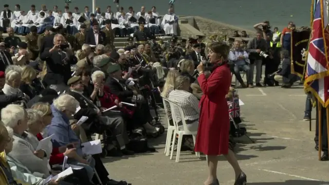 A singer performs The White Cliffs of Dover